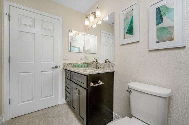 bathroom with tile patterned floors, vanity, and toilet