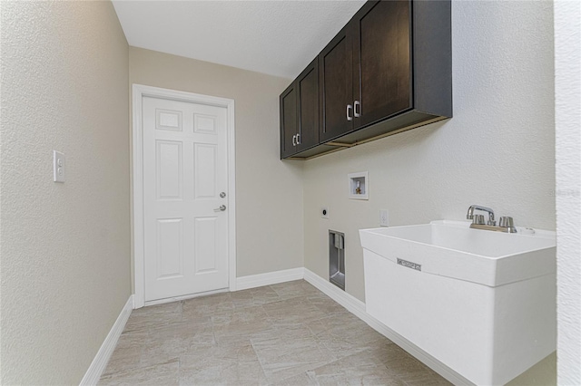 laundry room featuring cabinets, hookup for a washing machine, a textured ceiling, electric dryer hookup, and sink