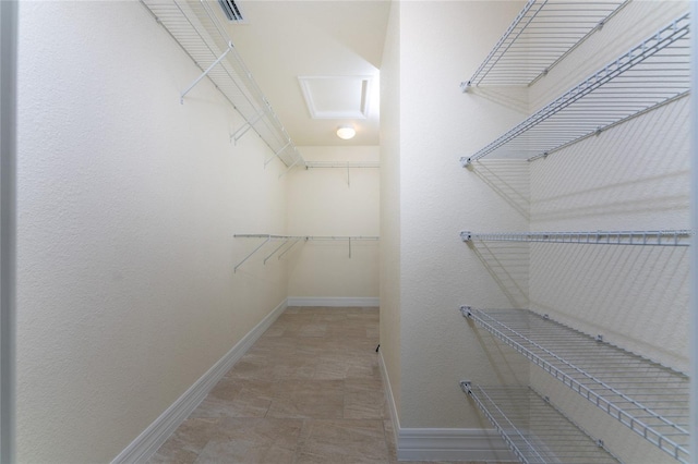 spacious closet with tile patterned flooring