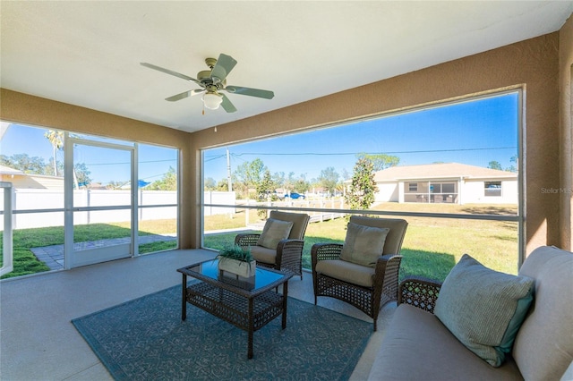 sunroom / solarium featuring ceiling fan