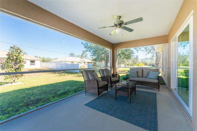 sunroom / solarium featuring ceiling fan