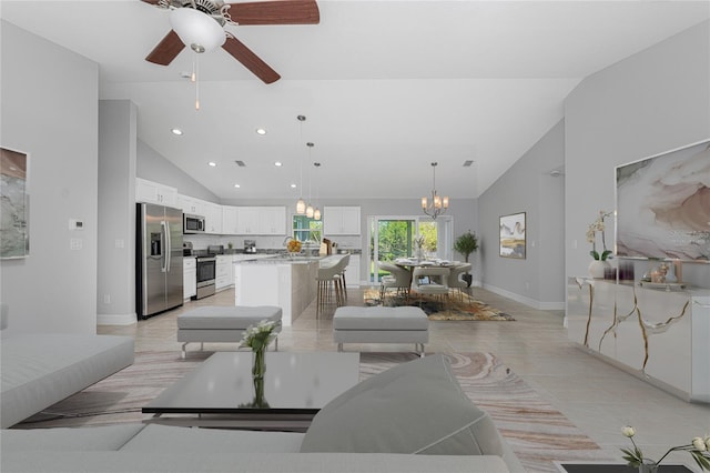 living room featuring light tile patterned floors, lofted ceiling, and a notable chandelier