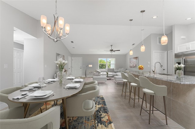 dining room with sink, ceiling fan, and high vaulted ceiling