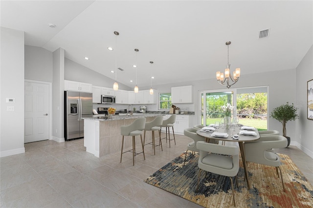 dining area featuring a notable chandelier, high vaulted ceiling, and light tile patterned floors