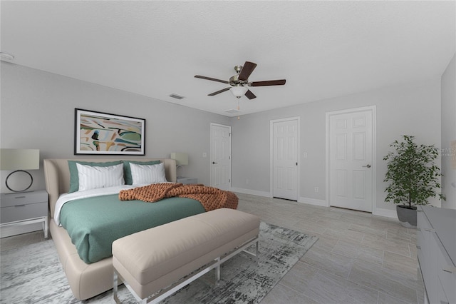 tiled bedroom featuring ceiling fan