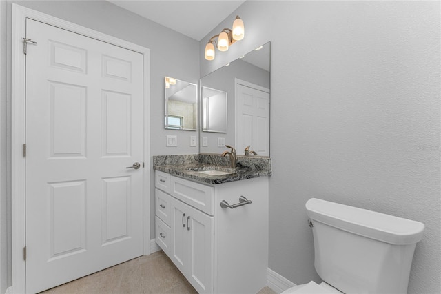 bathroom featuring toilet and vanity