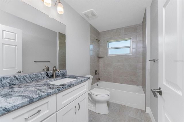 full bathroom featuring vanity, toilet, and tiled shower / bath combo