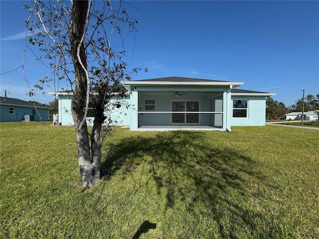 view of front of home featuring a front yard, central AC unit, and a sunroom