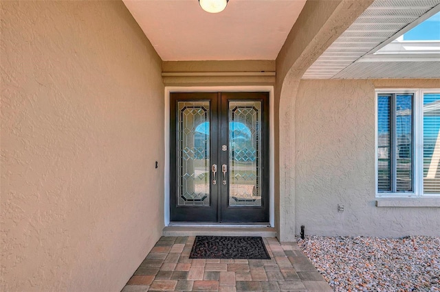 property entrance featuring french doors