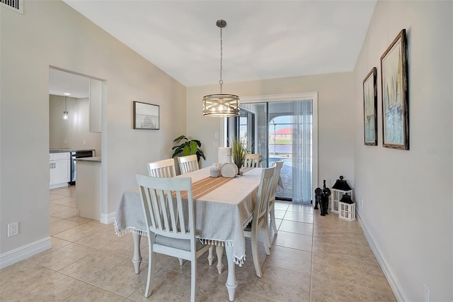 tiled dining room featuring a notable chandelier and lofted ceiling