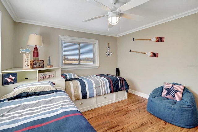 bedroom with ceiling fan, crown molding, and light hardwood / wood-style floors