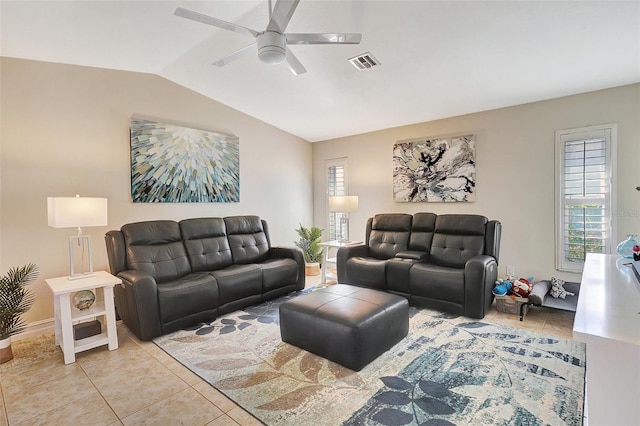 living room with ceiling fan, a healthy amount of sunlight, light tile patterned floors, and vaulted ceiling