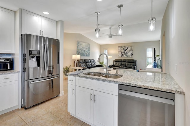 kitchen featuring white cabinets, stainless steel appliances, vaulted ceiling, and sink