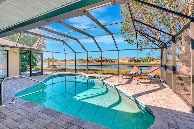 view of swimming pool featuring a water view, glass enclosure, and a patio area