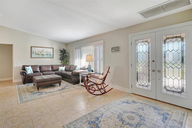 tiled foyer with french doors and lofted ceiling