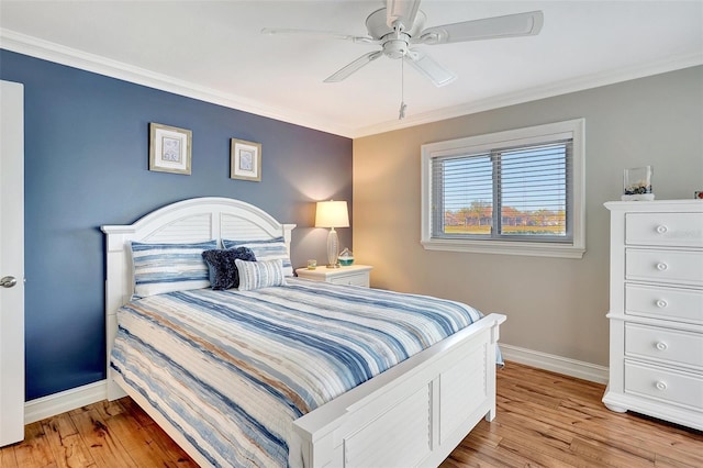 bedroom with crown molding, light hardwood / wood-style flooring, and ceiling fan