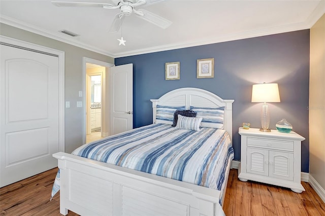 bedroom featuring ornamental molding, ceiling fan, and light wood-type flooring