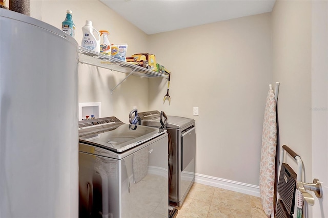 washroom with independent washer and dryer, heating unit, and light tile patterned floors