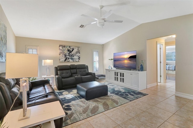 living room with ceiling fan, lofted ceiling, and light tile patterned floors