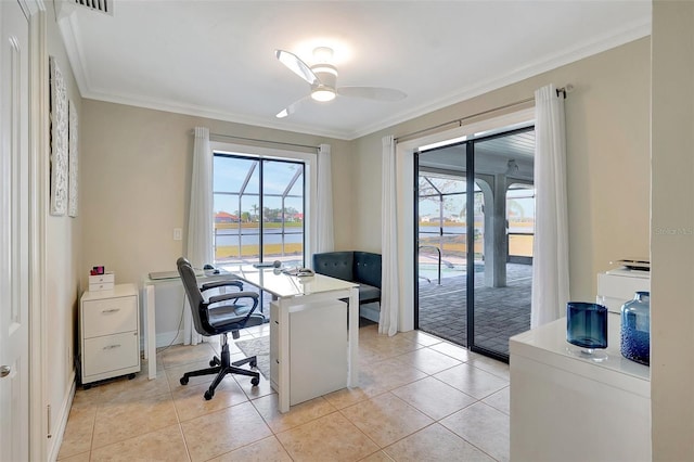 tiled office space with ceiling fan, ornamental molding, a healthy amount of sunlight, and a water view