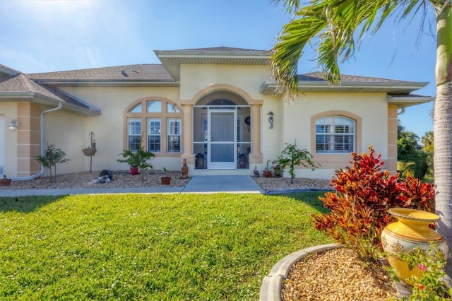 doorway to property with a yard