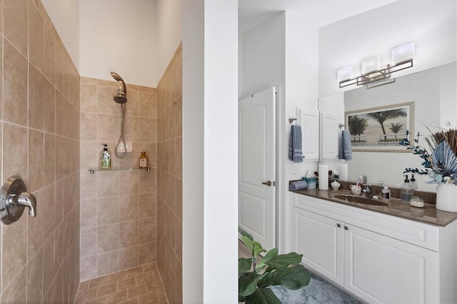 bathroom featuring vanity and tiled shower