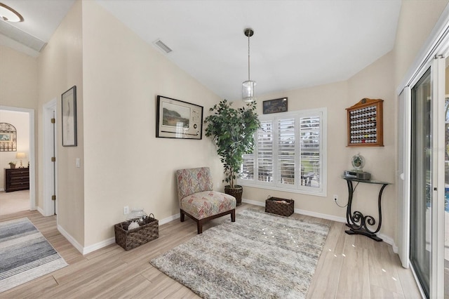 sitting room featuring light hardwood / wood-style floors and lofted ceiling