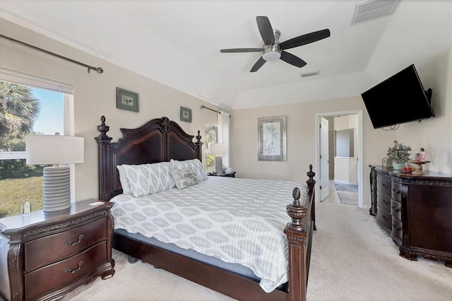 bedroom with ceiling fan, connected bathroom, and light colored carpet