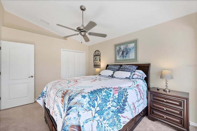 bedroom with ceiling fan, light colored carpet, a closet, and lofted ceiling