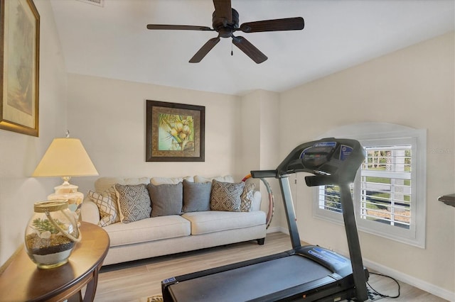 exercise area with light wood-type flooring and ceiling fan