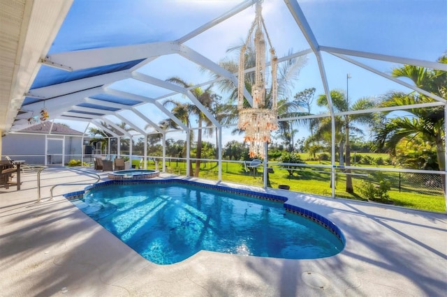 view of pool featuring glass enclosure, an in ground hot tub, and a patio