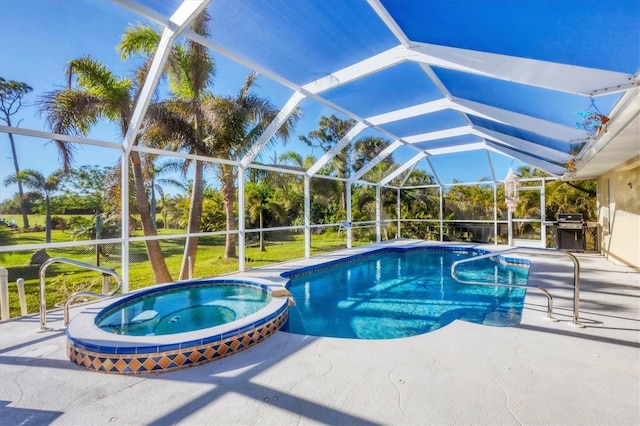 view of pool with an in ground hot tub, glass enclosure, grilling area, and a patio area