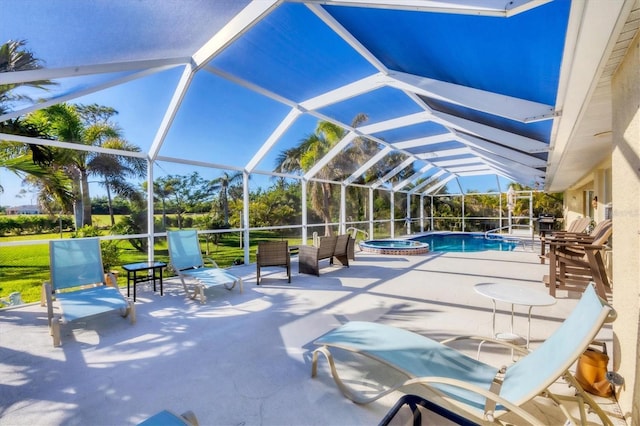 view of swimming pool featuring an in ground hot tub, a lanai, and a patio