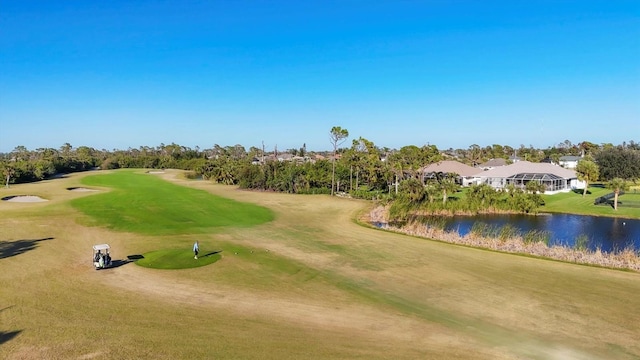 surrounding community featuring a lawn and a water view