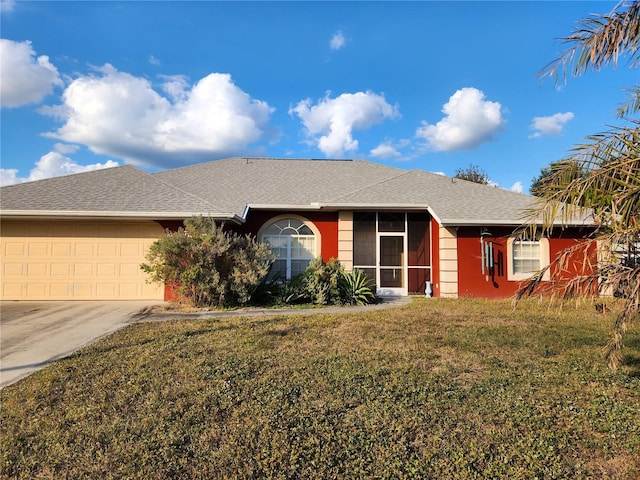 single story home with a garage and a front lawn