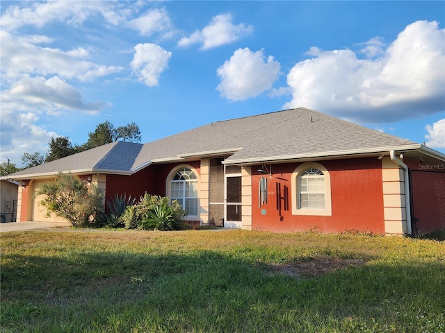 ranch-style home featuring a garage and a front lawn