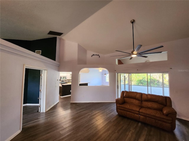 living room featuring dark hardwood / wood-style flooring, high vaulted ceiling, plenty of natural light, and ceiling fan