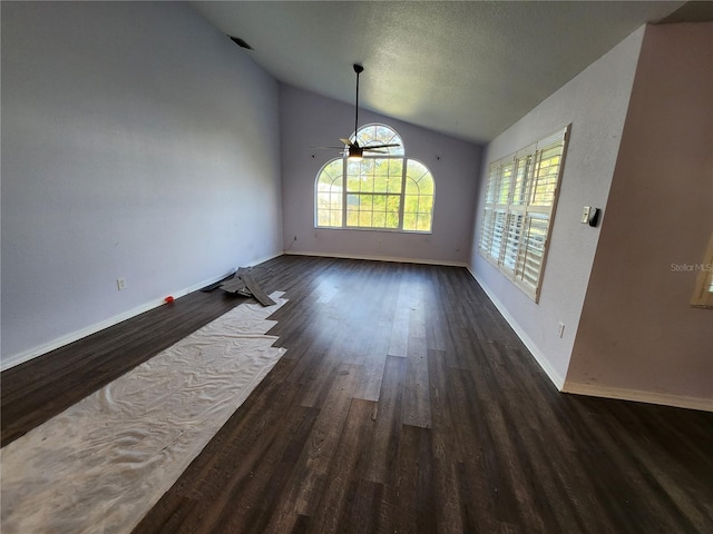 unfurnished dining area with a textured ceiling, dark hardwood / wood-style flooring, ceiling fan, and lofted ceiling