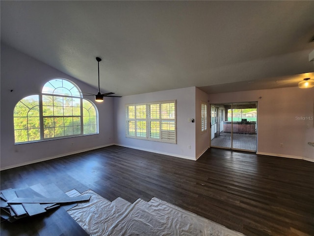 unfurnished living room with lofted ceiling, ceiling fan, and dark wood-type flooring