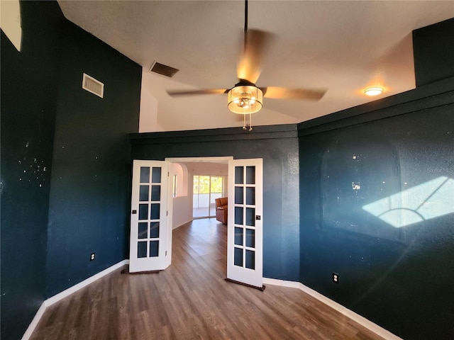 empty room with french doors, hardwood / wood-style flooring, and ceiling fan