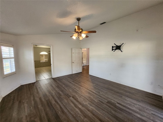 unfurnished bedroom with ceiling fan, dark hardwood / wood-style flooring, and vaulted ceiling