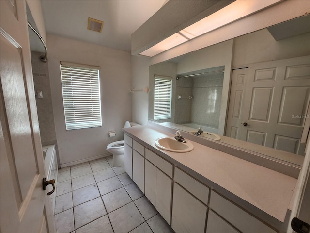 bathroom with tile patterned flooring, vanity, and toilet