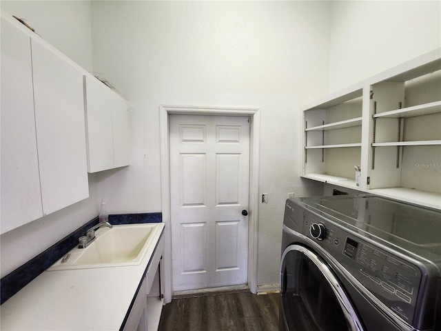 washroom featuring cabinets, dark hardwood / wood-style flooring, washer / clothes dryer, and sink