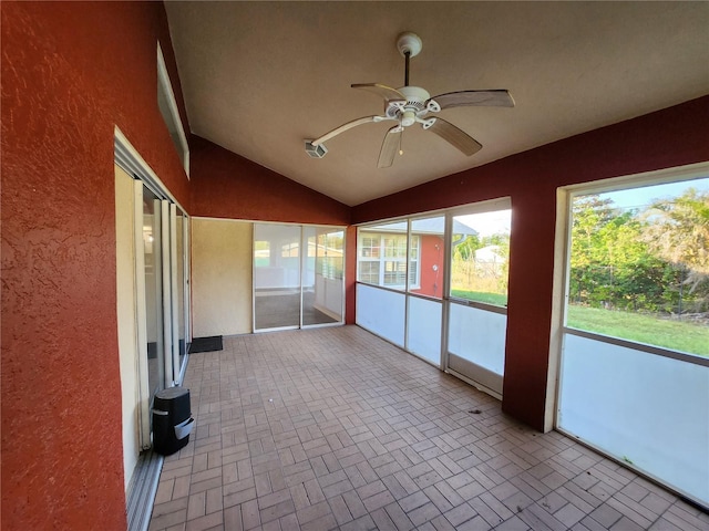 unfurnished sunroom featuring ceiling fan and lofted ceiling