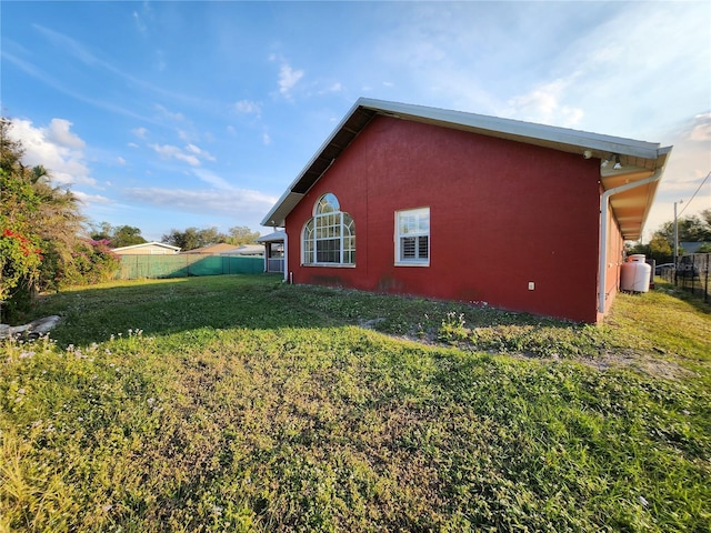 view of side of property with a yard