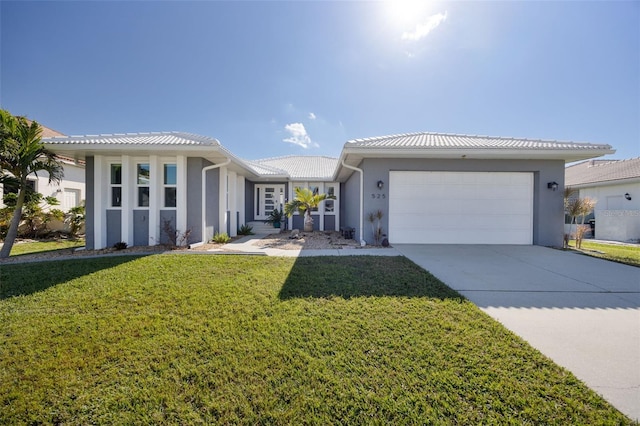 view of front of house featuring a front yard and a garage