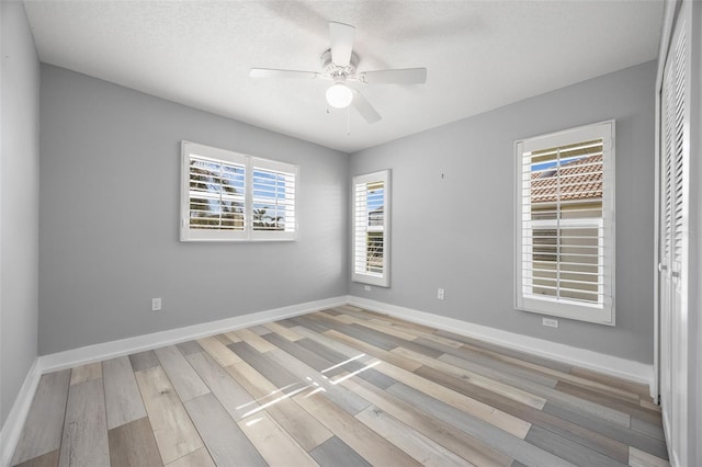 unfurnished room with ceiling fan and light hardwood / wood-style flooring