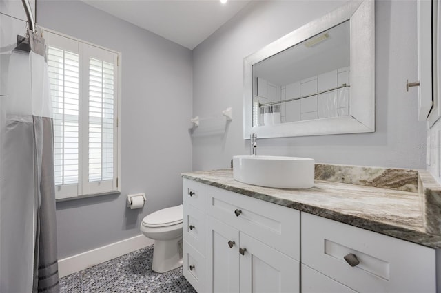 bathroom with tile patterned flooring, vanity, and toilet