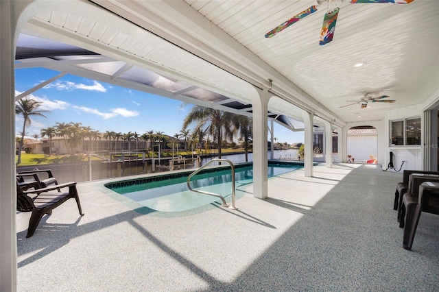 view of swimming pool with a lanai, ceiling fan, a patio area, and a water view