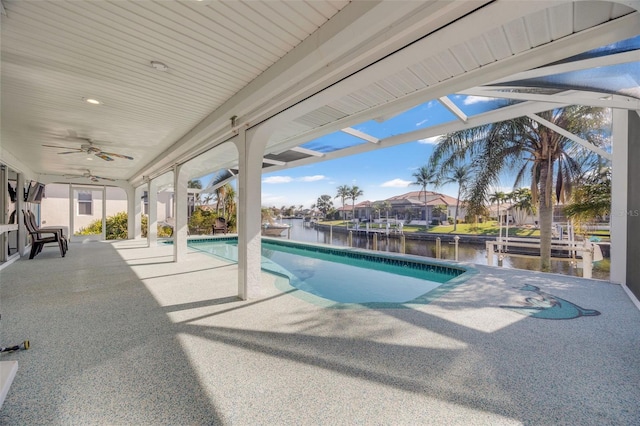 view of pool featuring ceiling fan, a patio area, and a water view